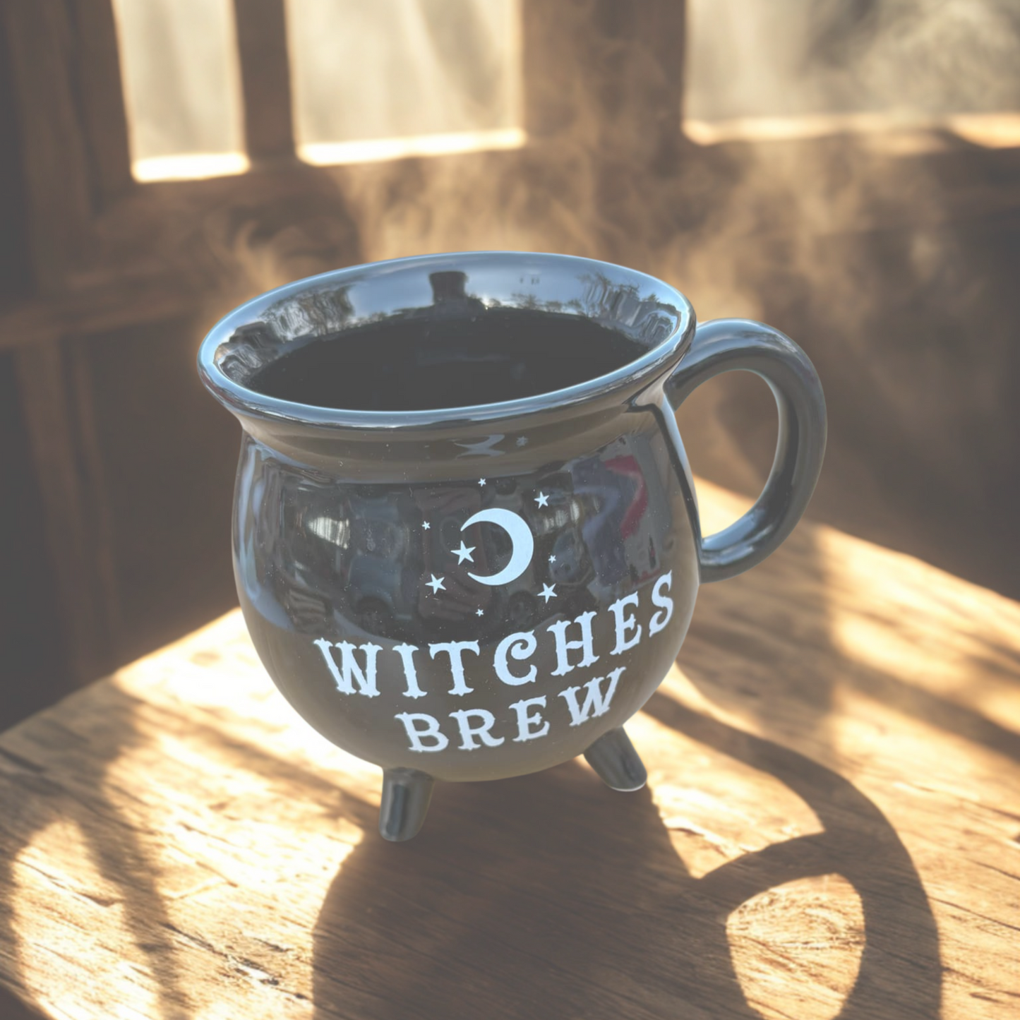 Mug labeled 'Witches Brew' on a wooden surface with sunlight casting shadows