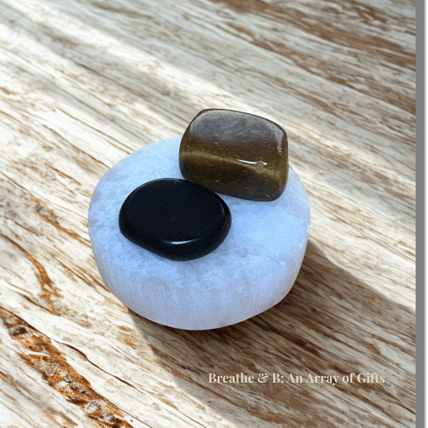 Protect & Ground Crystal Set – Selenite Plate, Black Obsidian and Tiger’s Eye on a wooden table