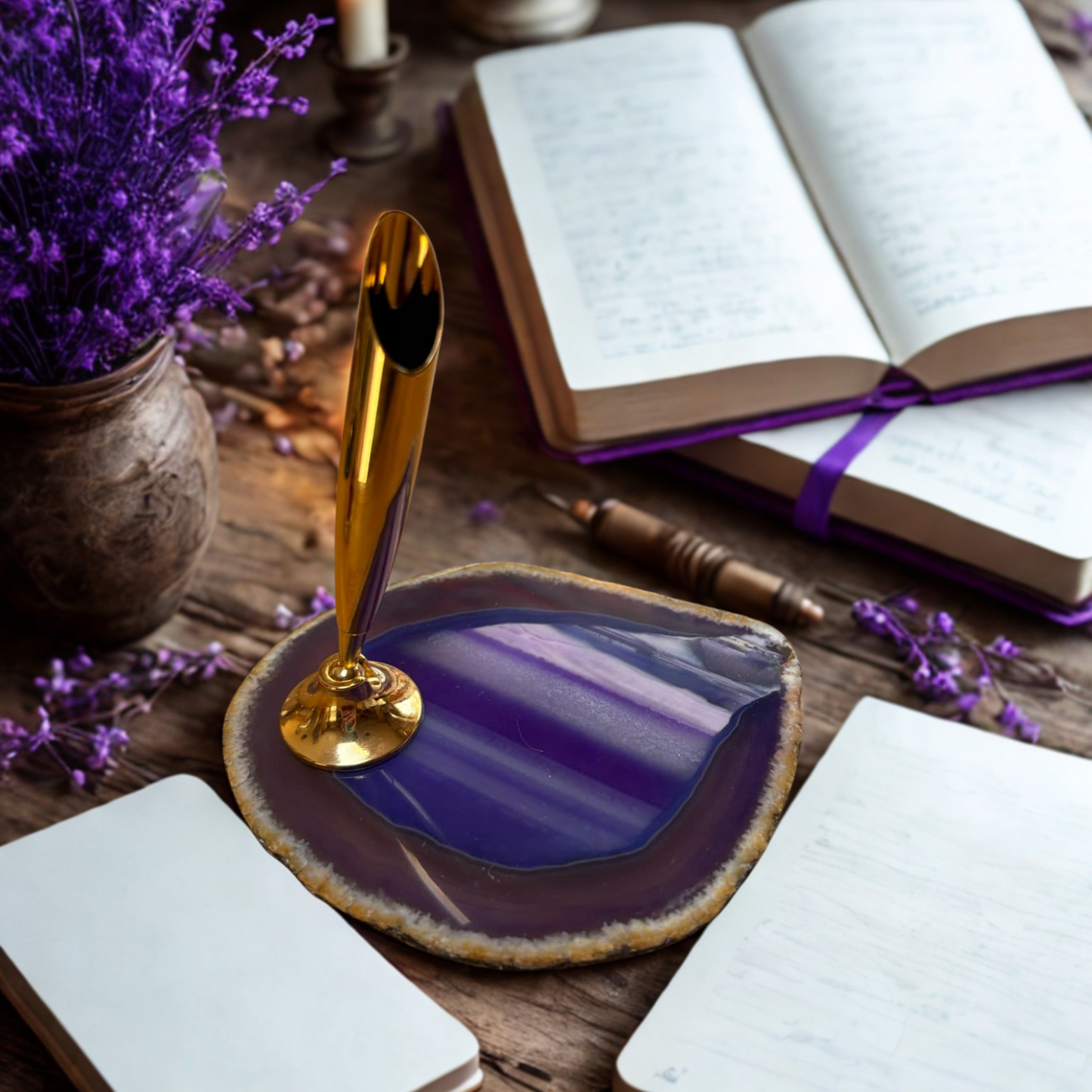 Purple agate slice with pen holder on a wooden surface with books and lavender.