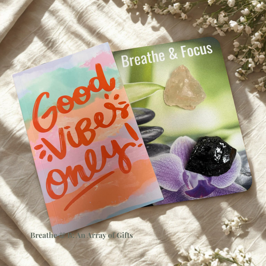 Affirmation Mouse Pad "Breathe & Focus", Good Vibes Only notebook, salt chunk and black tourmaline on a textured surface with flowers around.