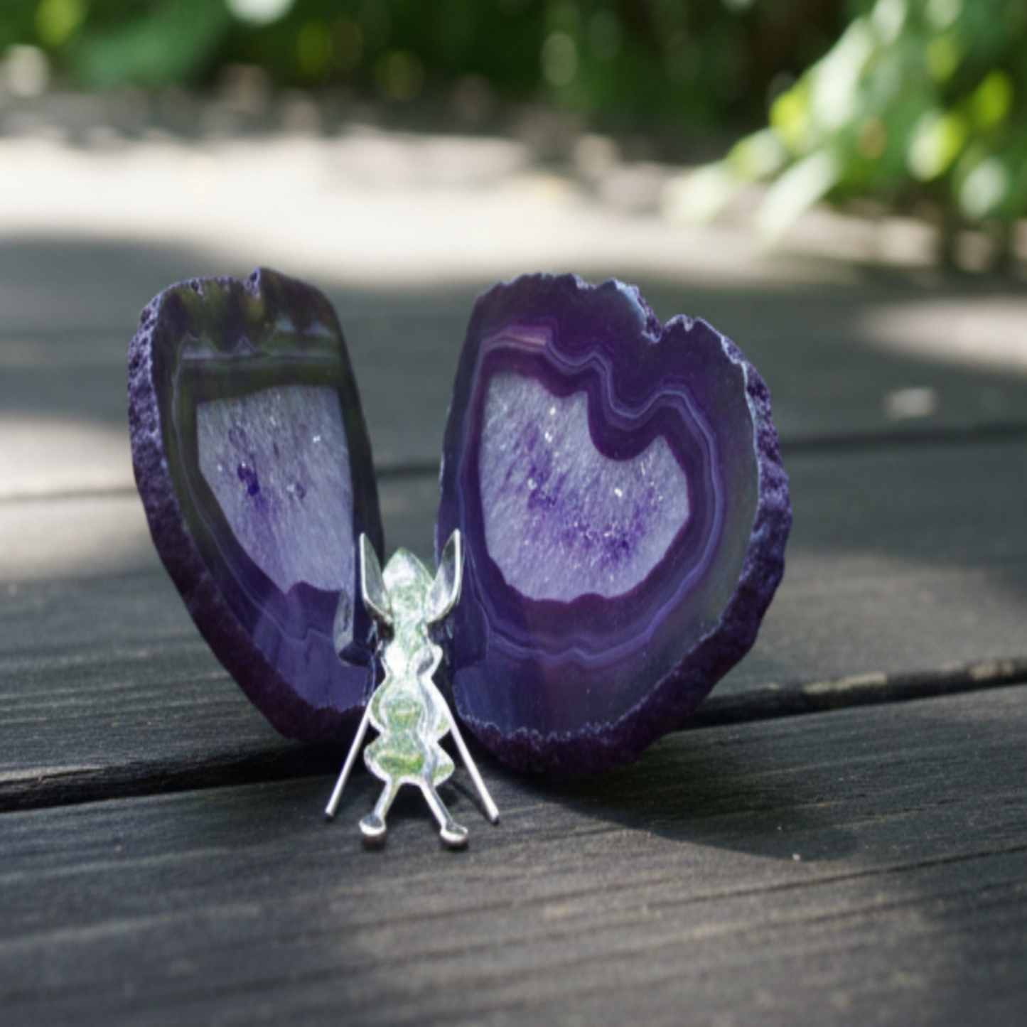 Butterfly purple agate stone on a wooden surface