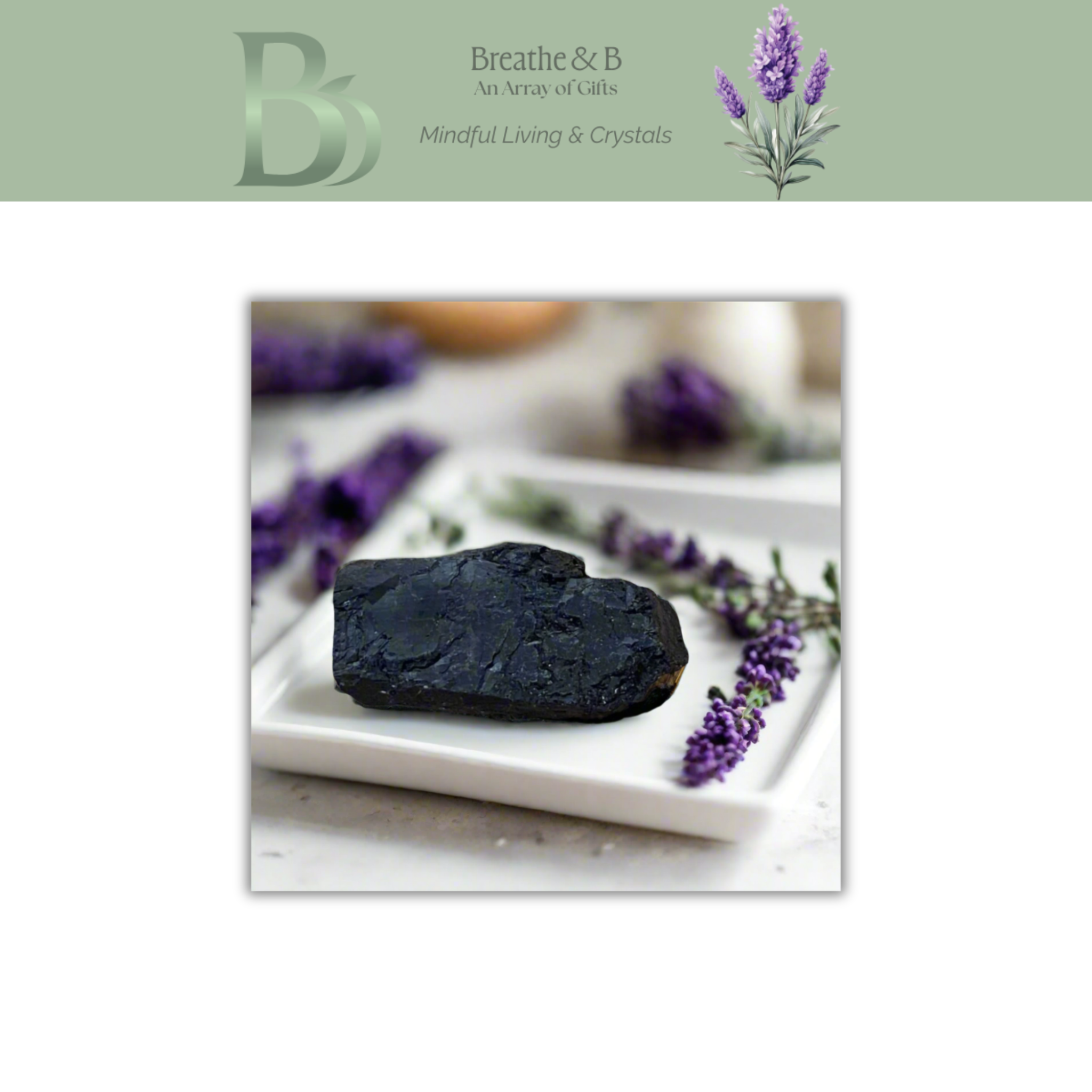 Natural black tourmaline stone close-up showing raw texture, used for grounding, protection and emotional balance with Breathe & B branding