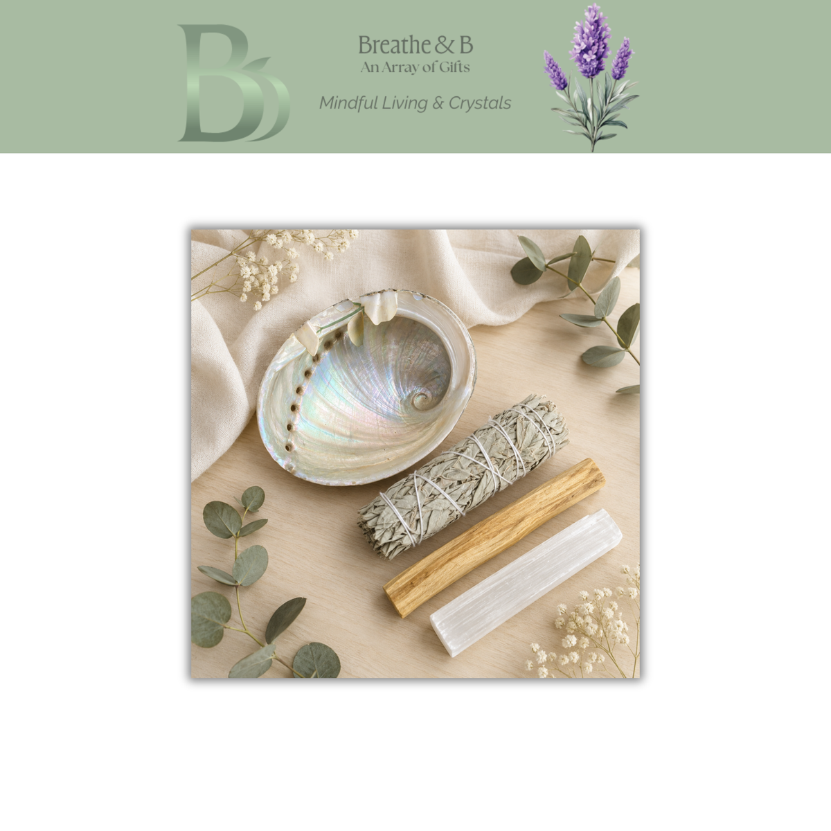 A styled flat-lay of Energy Cleansing Ritual Kit, featuring a white and iridescent abalone shell bowl, a sage smudge bundle, a palo santo stick, and a selenite rod arranged on a light wood surface with eucalyptus leaves and cream fabric. The top banner displays the brand logo and name 'Breathe & B'.