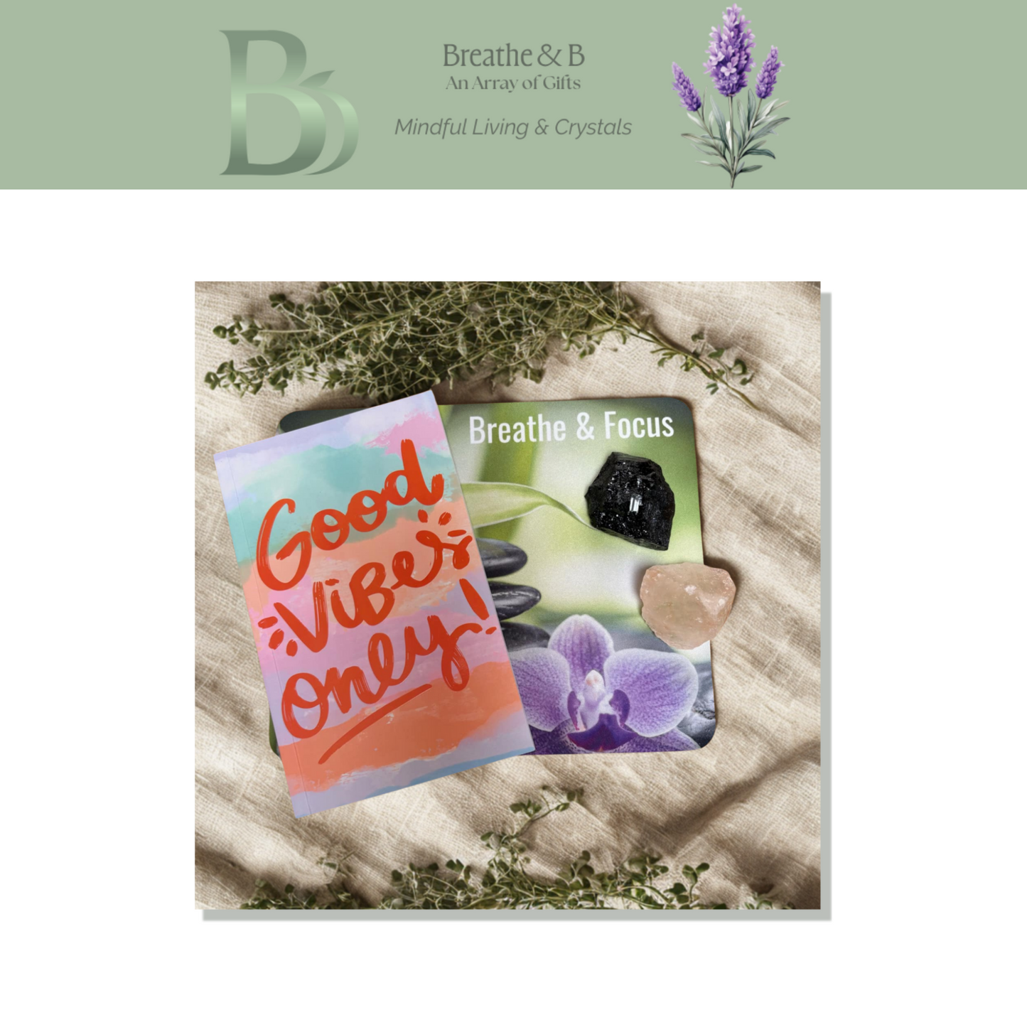 Breathe & Focus affirmation mouse pad, good vibes note book, himalayan salt chunk, tourmaline cluster on a textured surface with plants, branded 'Breathe & B'.