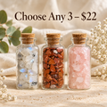 Three miniature glass bottles filled with assorted natural crystal chips and finished with cork stoppers. Image displays Choose Any 3 for $22, highlighting the mix-and-match crystal gift bundle from Breathe & B.