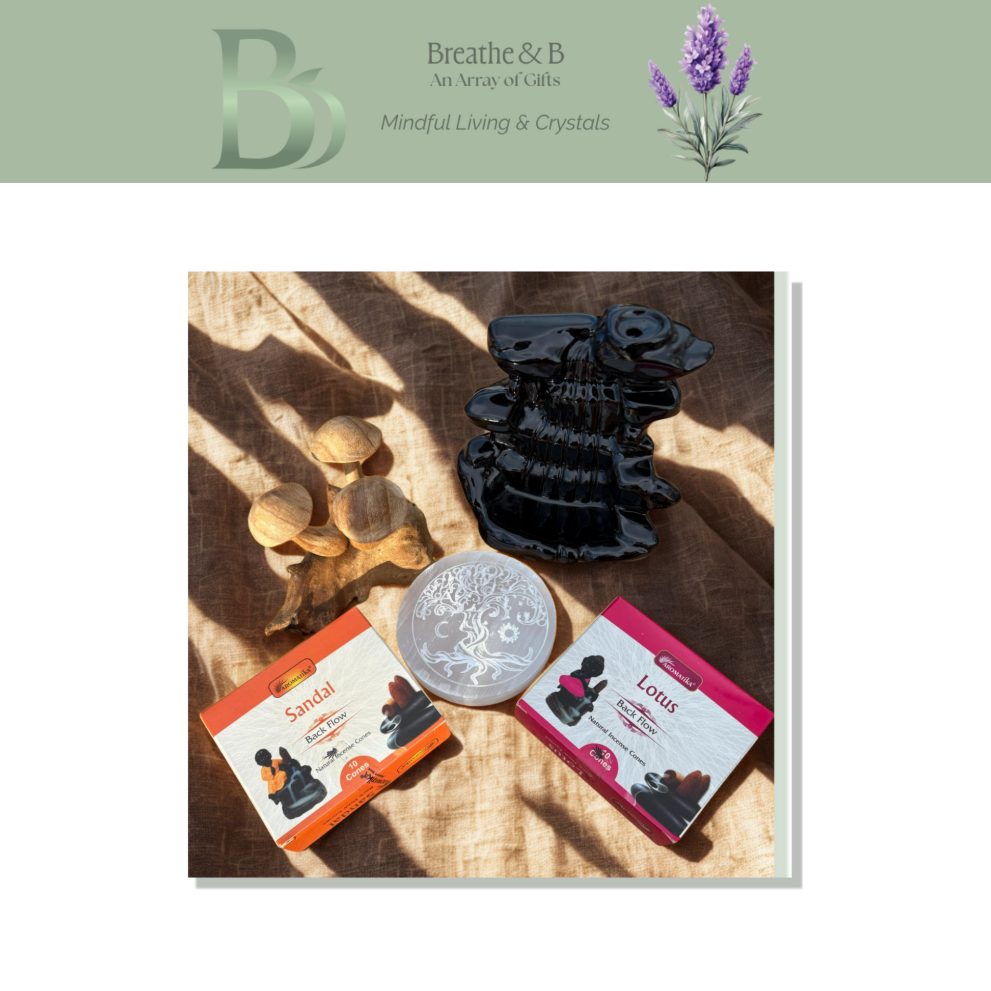 Collection of items including a black waterfall burner, selenite charging plate, and incense cones and wooden mushrooms