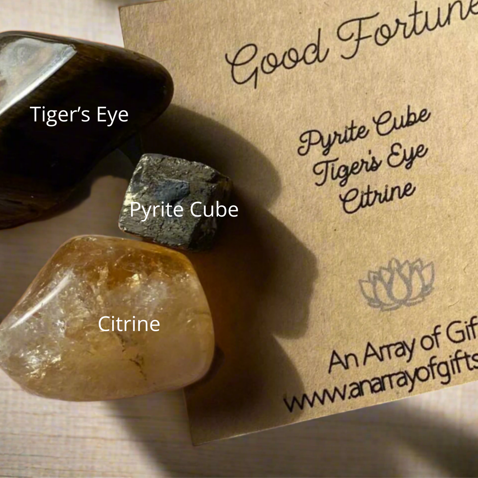 Crystal kit showing labelled pyrite, citrine and tiger's eye stones for abundance and prosperity