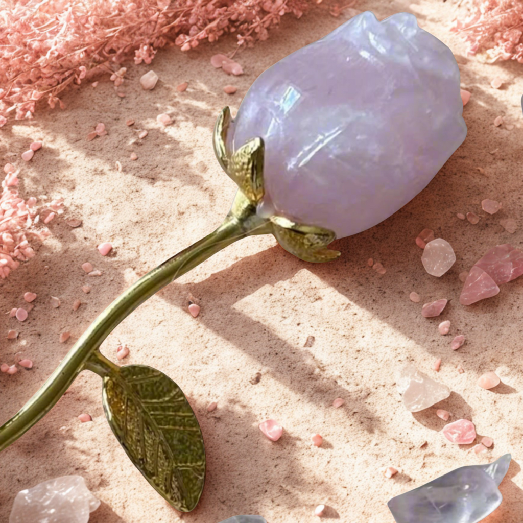 Decorative crystal flower with rose quartz on a textured surface with pink flowers and crystals.