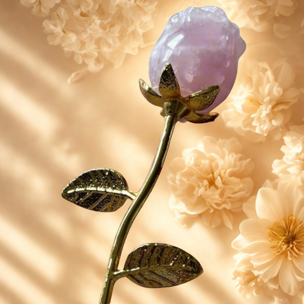 Decorative crystal rose quartz flower with gold stem against a soft floral background