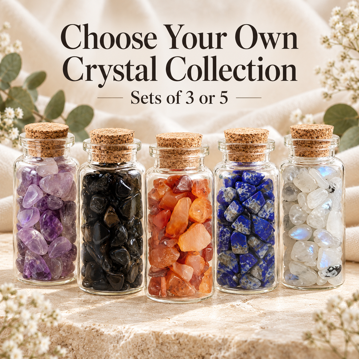 Five miniature glass crystal chip bottles with cork stoppers, showcasing different colourful natural crystals. Promotional text reads Choose Your Own Crystal Collection, Sets of 3 or 5. Mix and match crystal bottles from Breathe & B.