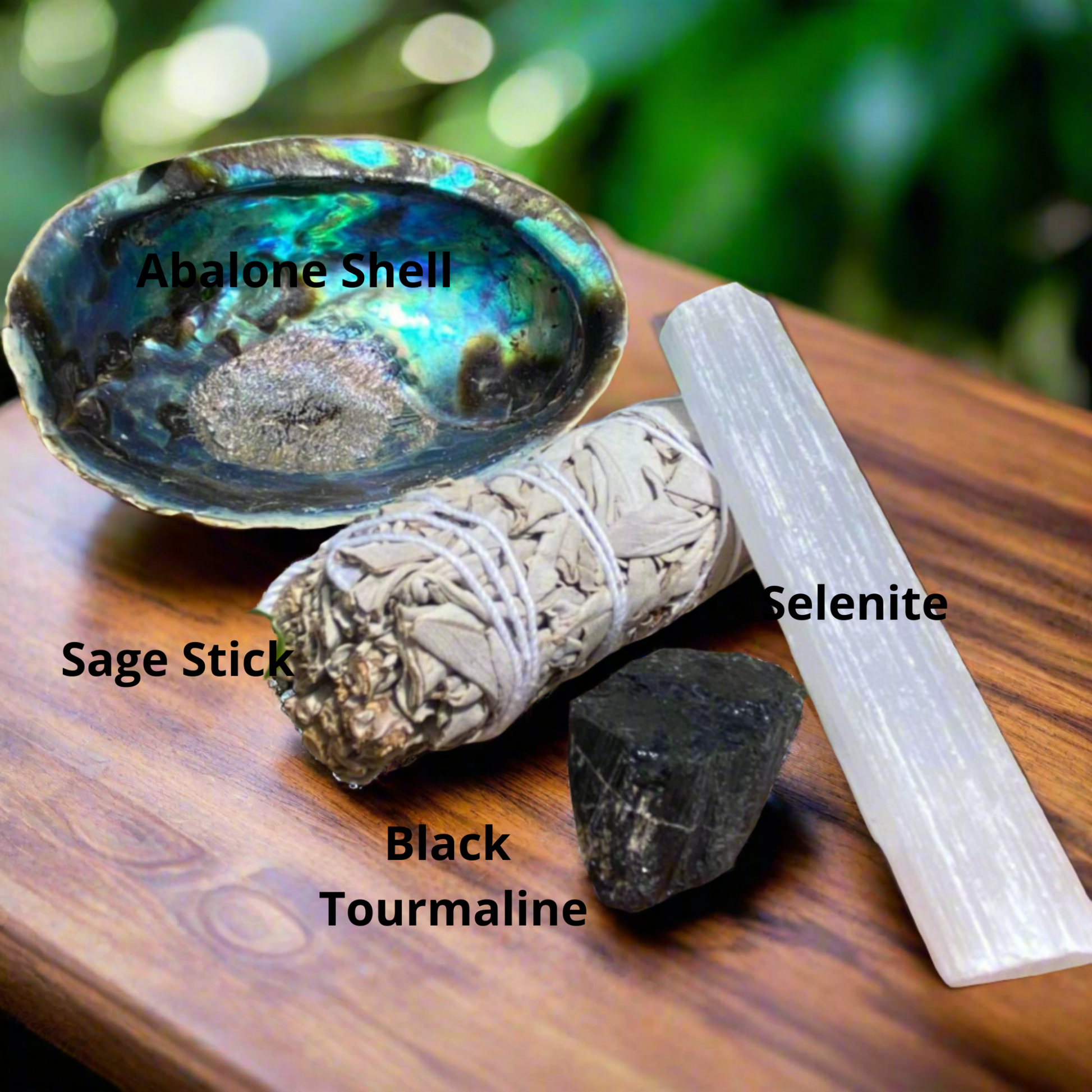 House cleansing protection kit showing labelled sage, selenite rod, black tourmaline and abalone shell for spiritual cleansing