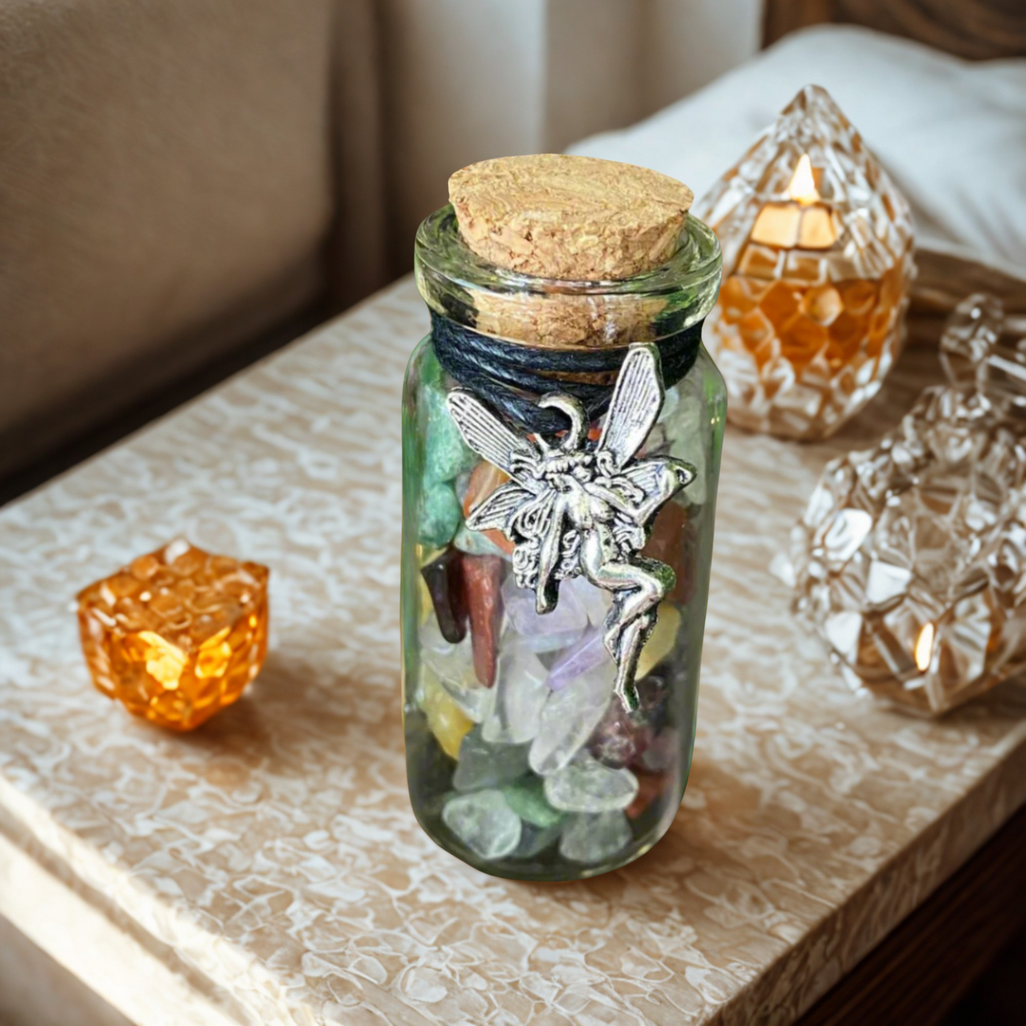 Glass jar with miced crystal chips with fairy charm on a textured surface