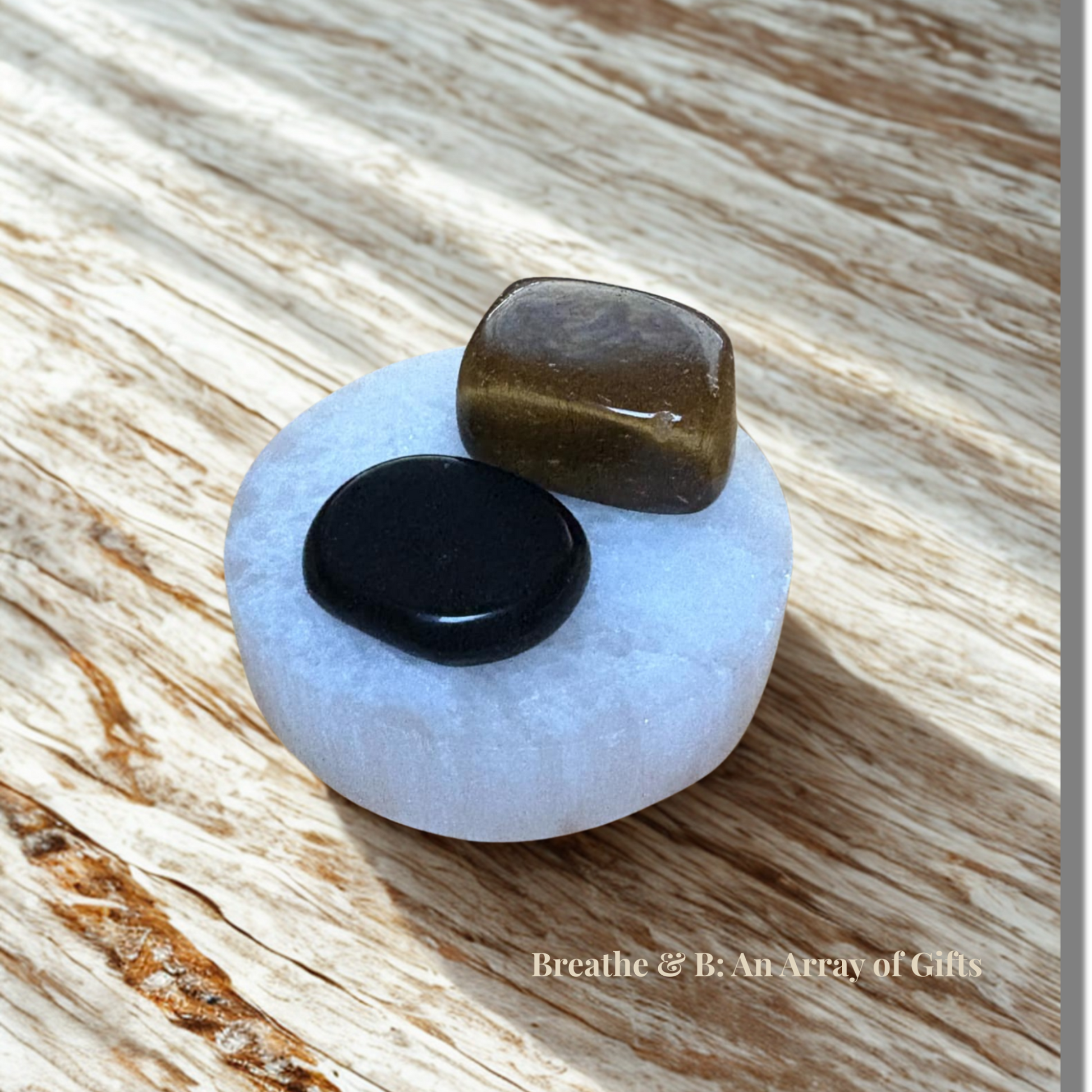 Protect & Ground Crystal Set – Selenite Plate, Black Obsidian and Tiger’s Eye on a wooden table