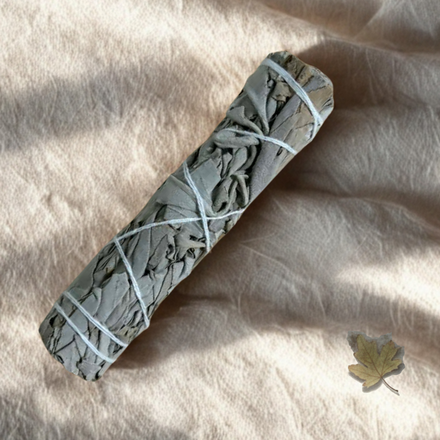 Natural dried sage smudge stick tied bundle used for energy cleansing, spiritual purification and mindfulness rituals.