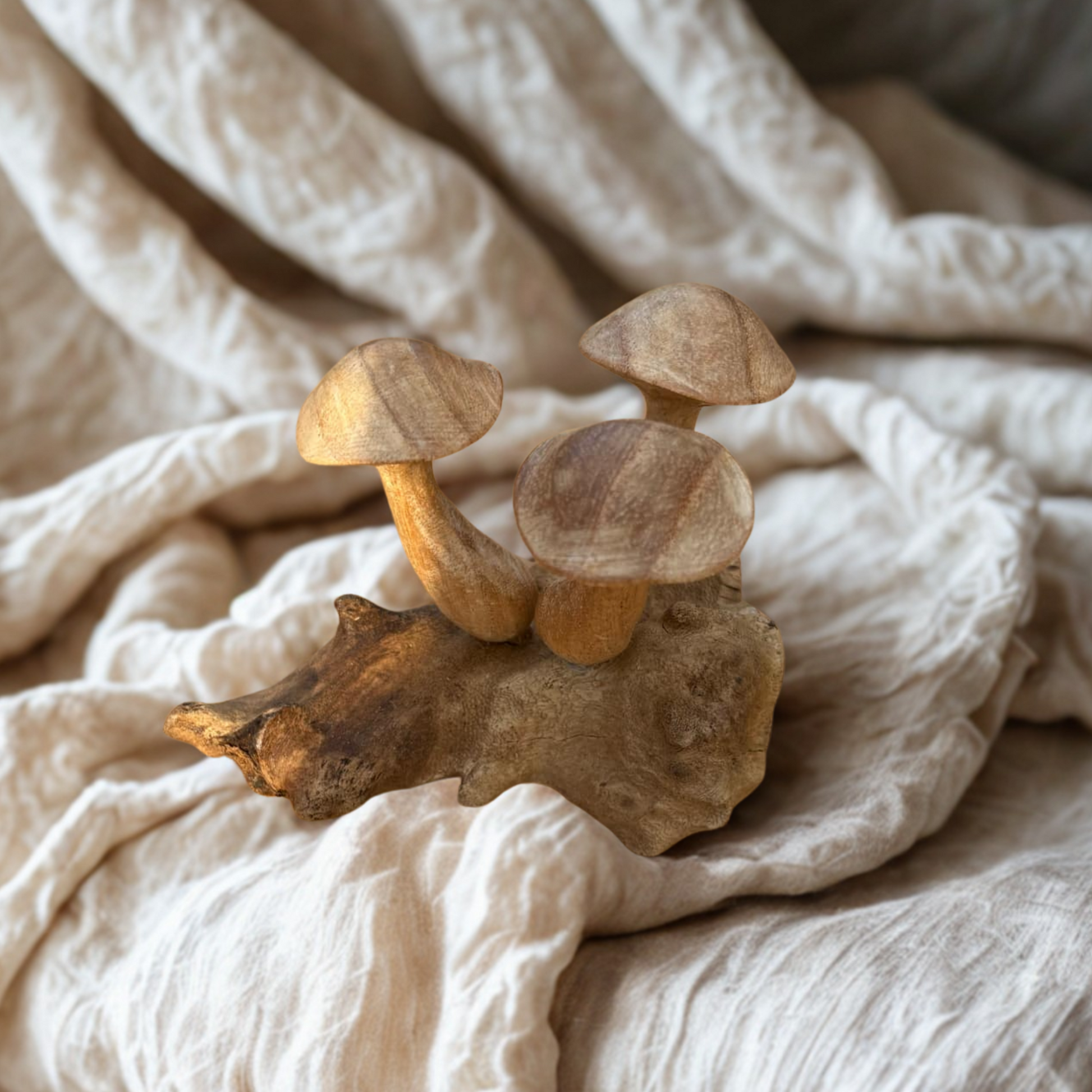 Wooden mushroom on a textured beige fabric background